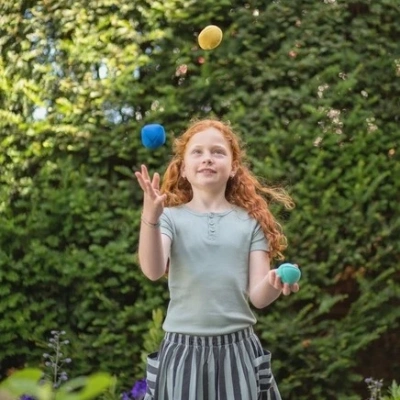 Kind leert jongleren met kleurrijke BS Toys jongleerballen