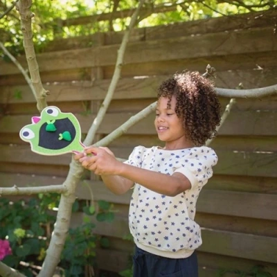 Meisje speelt het Gekko spel van BS Toys en vangt de vliegen met het klittenband racket